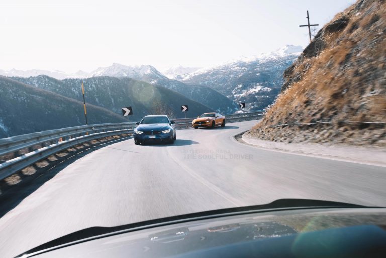 cars running on an alpine road