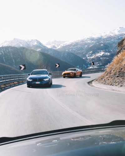 cars running on an alpine road